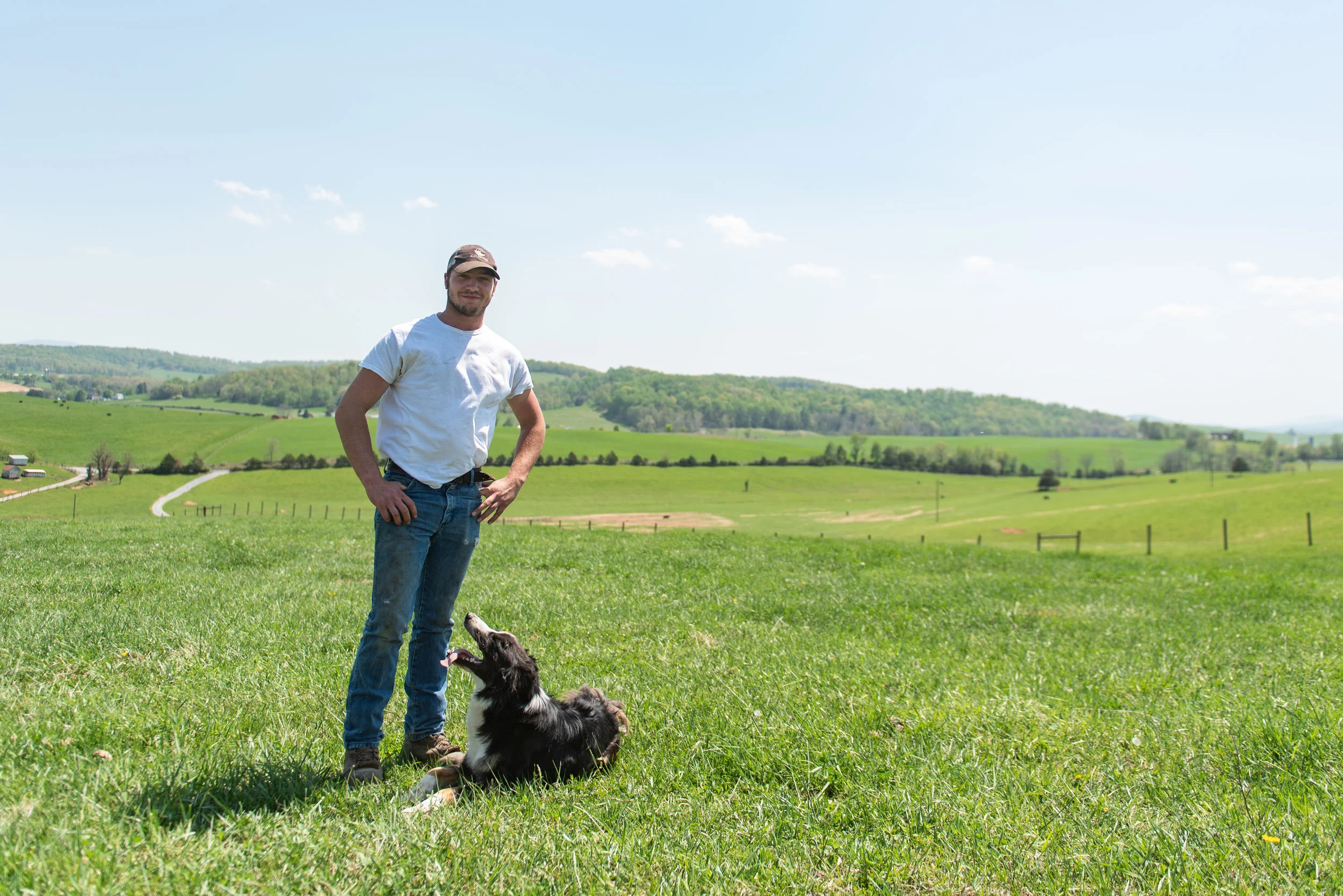 Luke Grant stands on his parent’s farm with his dog, Cinch.