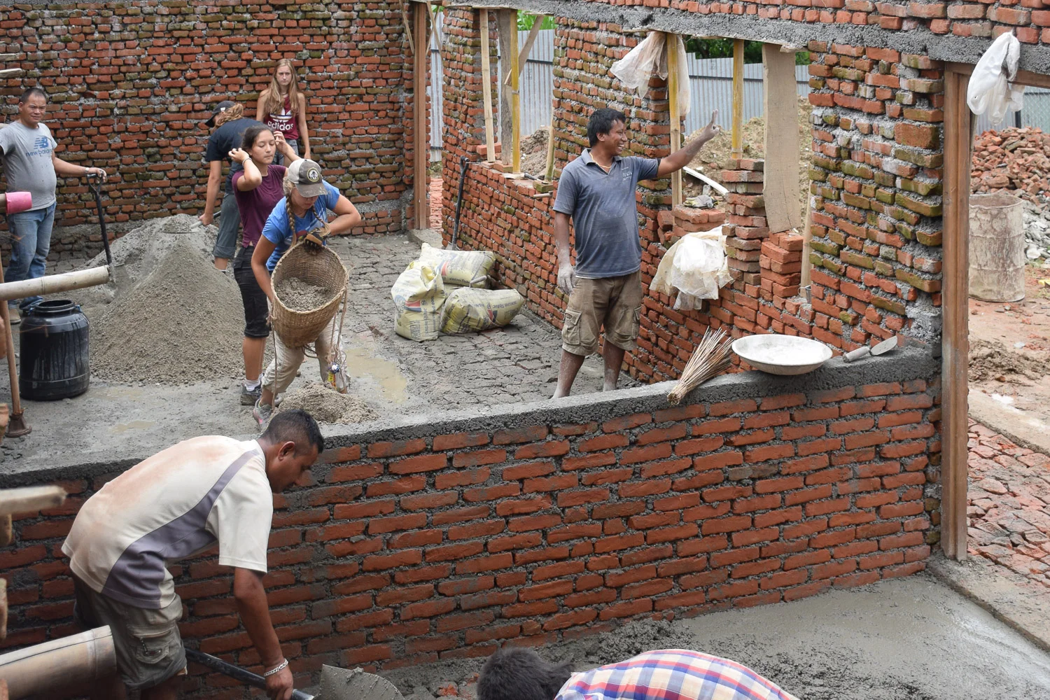 Volunteer students are helping to build a home for girls, working together with the local community.