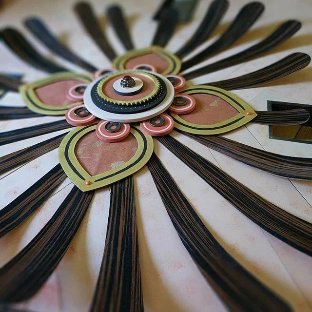 Center mandala complete. Steamed and bent zebra wood, rice paper insets, antique bracelet, and brooch.