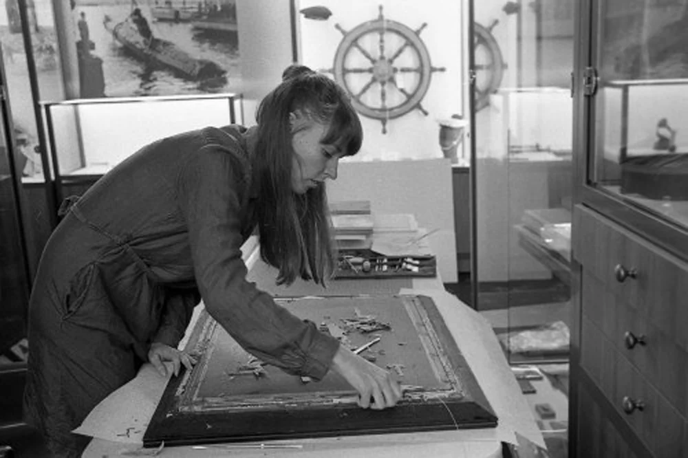 Meghan Ellis removing the photograph described above from its frame / Photograph by Dominic King