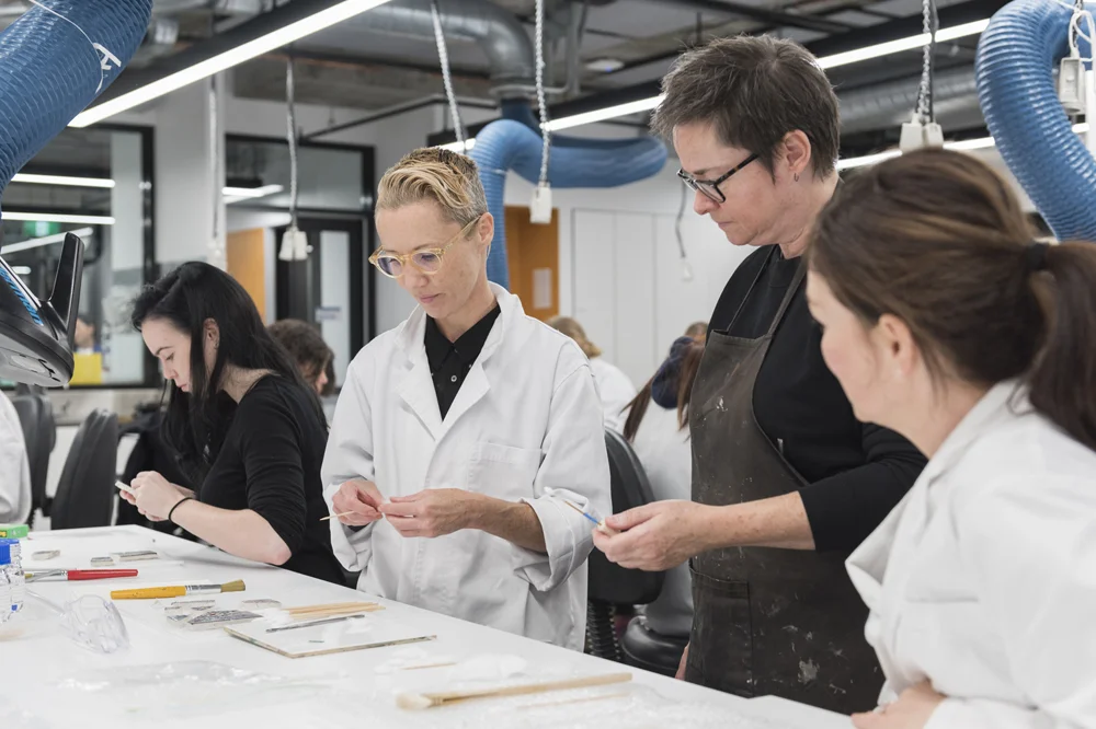 Lauren Acland and Lisa Mansfield (both left) learn some nifty swab-making tricks from ceramics conservator Penny Byrne