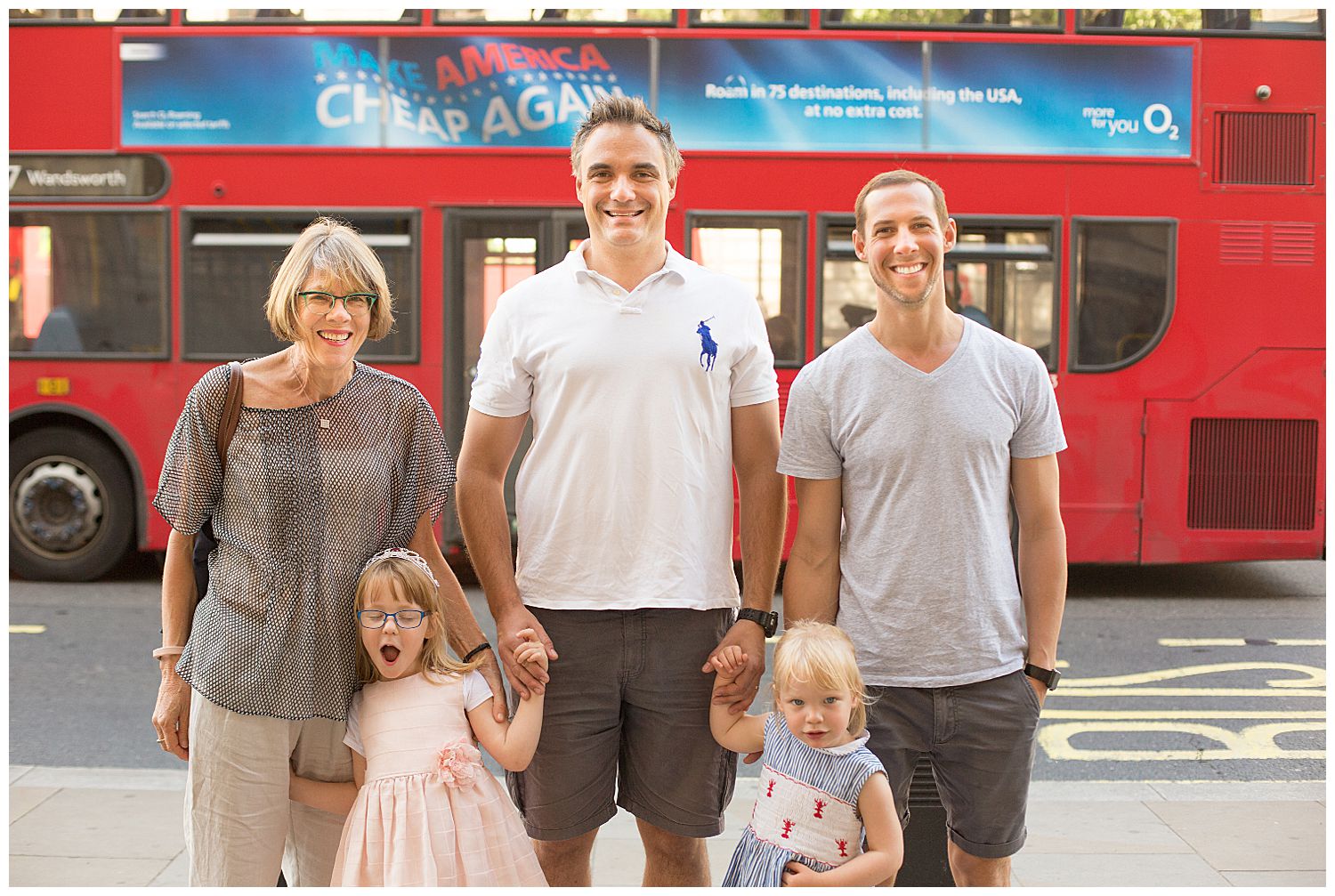 family in front of London bus
