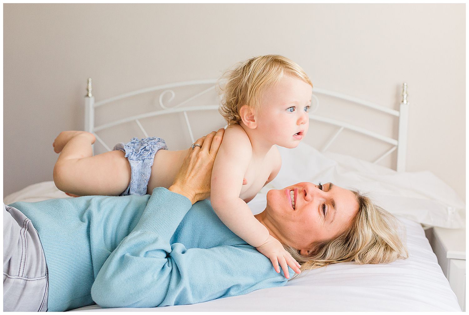 mum and baby girl on bed