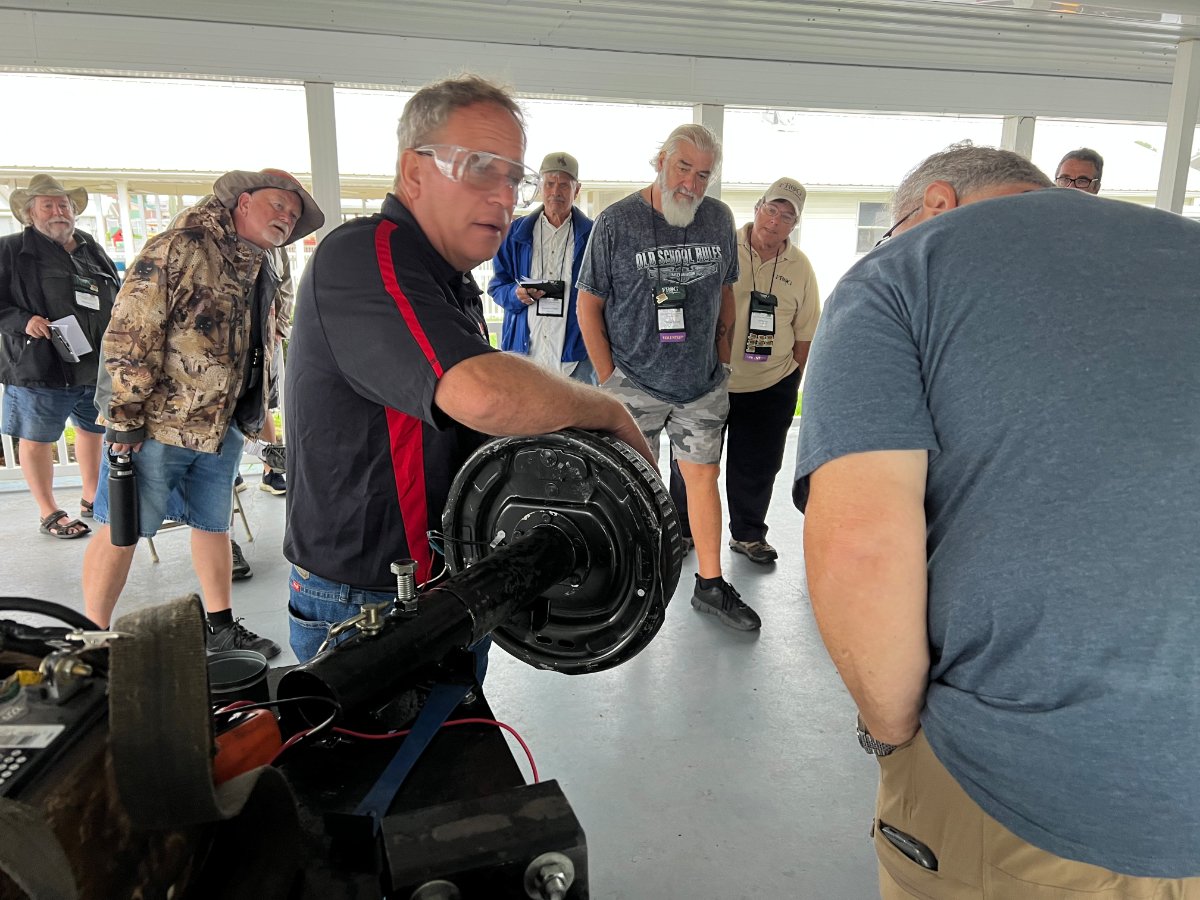 Curious attendees learned to service wheel bearing and brakes from a Dexter team member.jpg