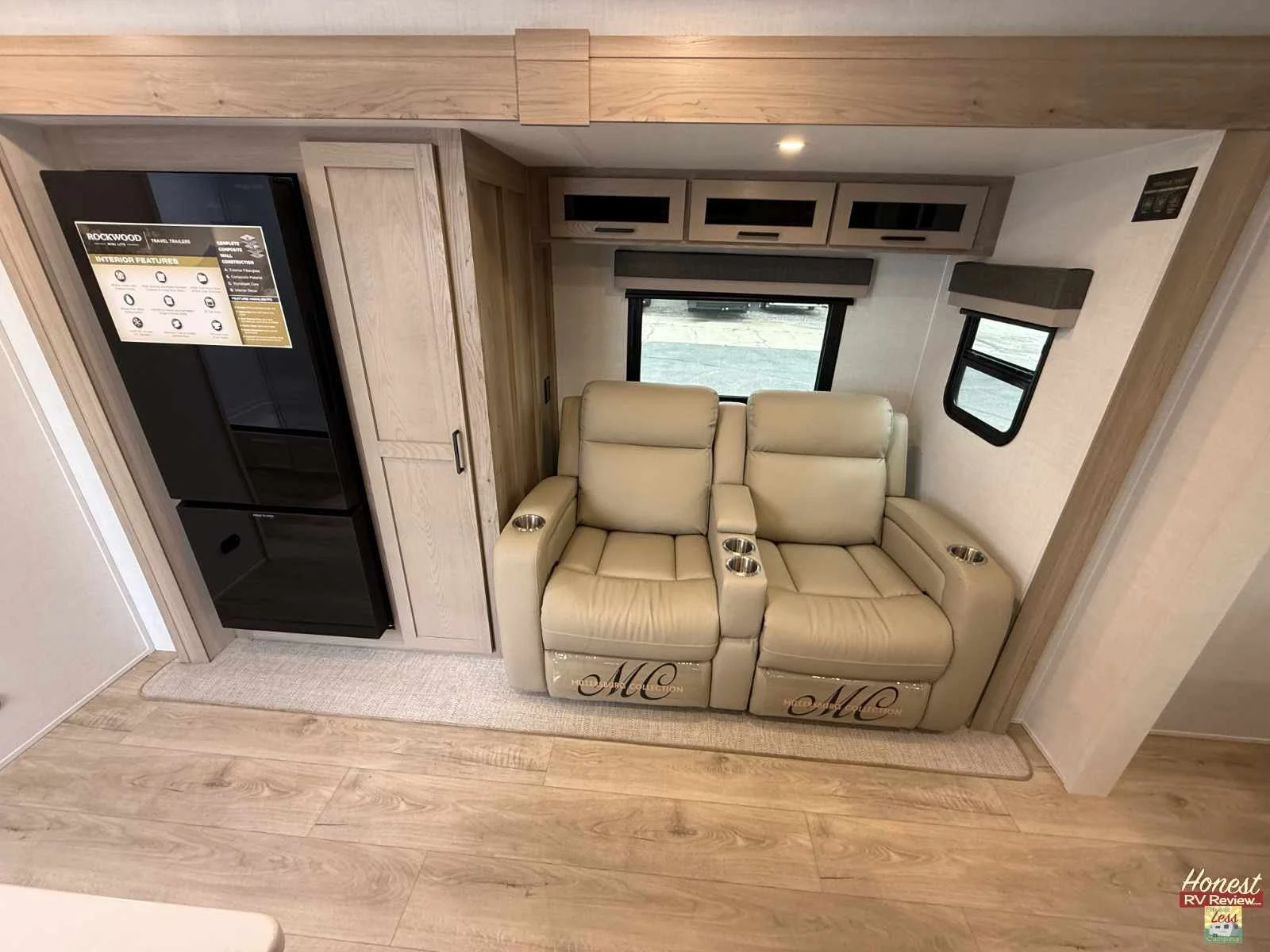 Theater seats and a 12 volt fridge with dual-swing doors in the slide of the Rockwood Mini Lite 2525RB.jpg