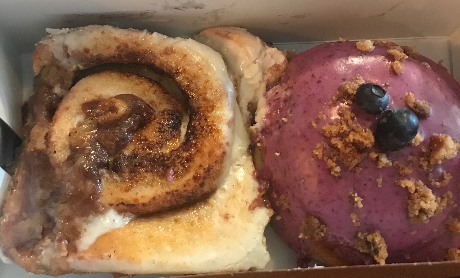 The cinnamon roll donut (left) and the blueberry cheesecake donut (right).
