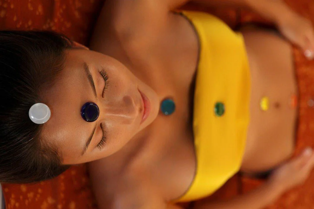 Special chakra matched stones placed for resetting the vibration of the chakras energy