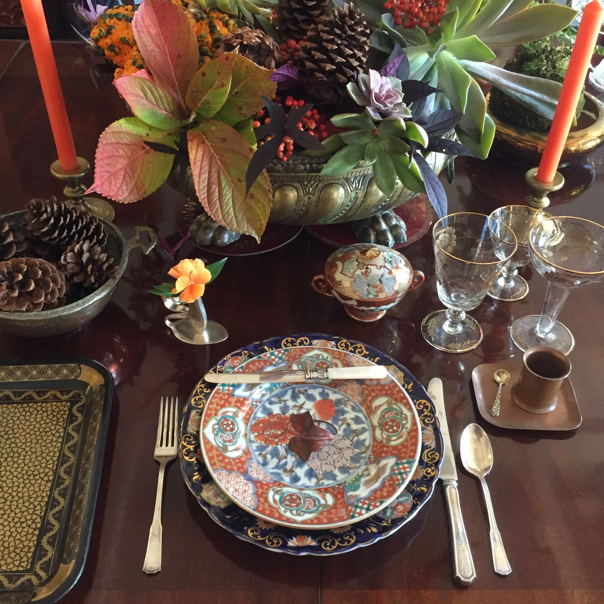 Thanksgiving tablescape with succulents, berries and fall foliages in a vintage brass planter