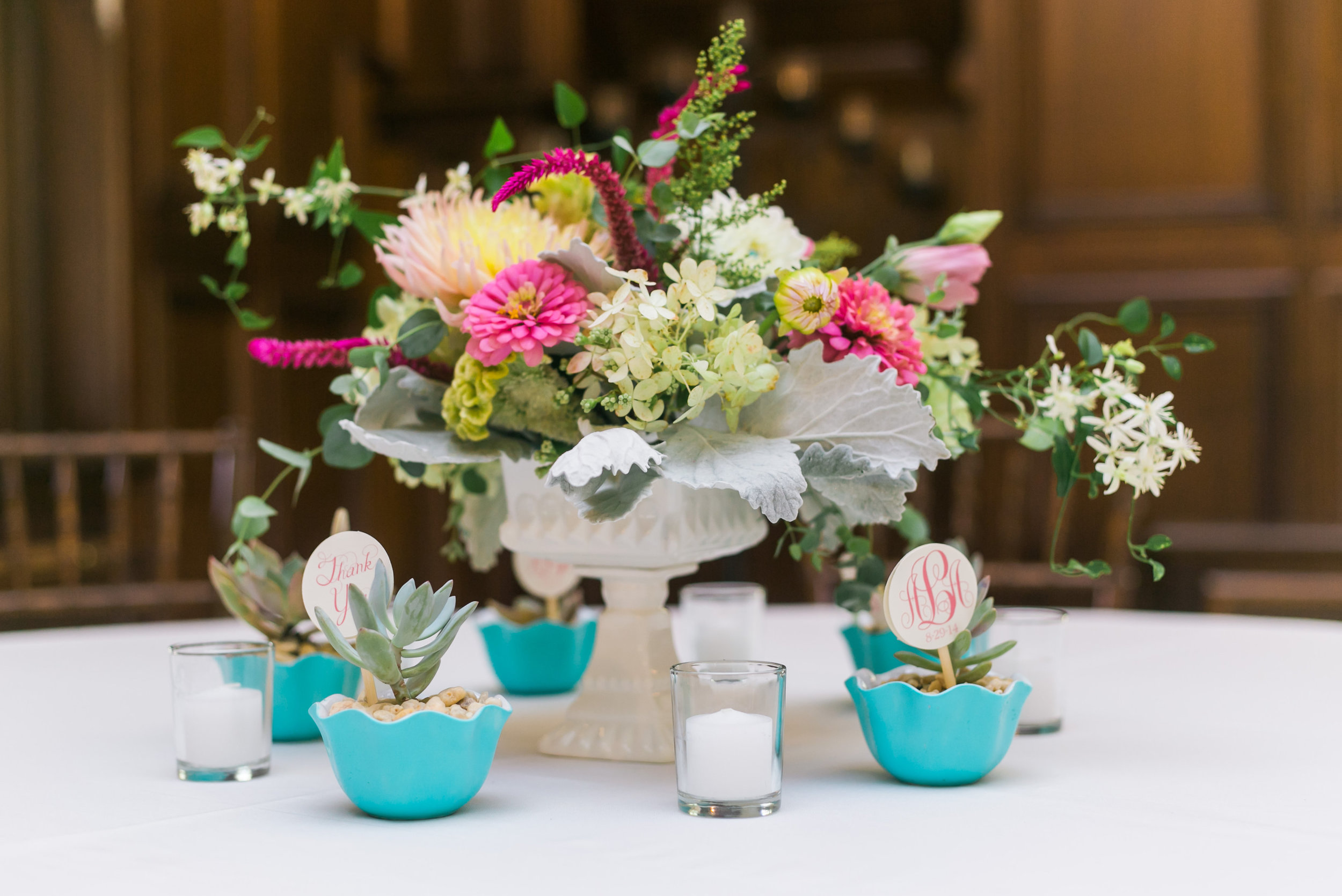 mid summer centerpiece in a vintage candy dish with table numbers