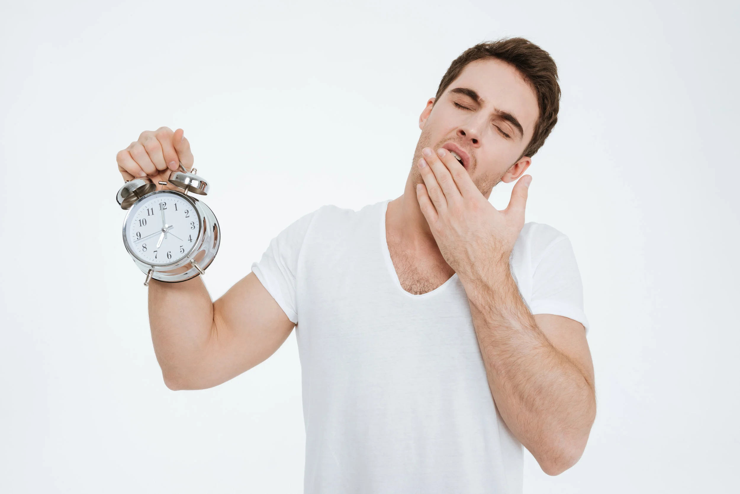 graphicstock-picture-of-young-yawning-man-dressed-in-white-t-shirt-standing-over-white-background-showing-alarm-to-camera_Bdx0L5hU3e.jpg