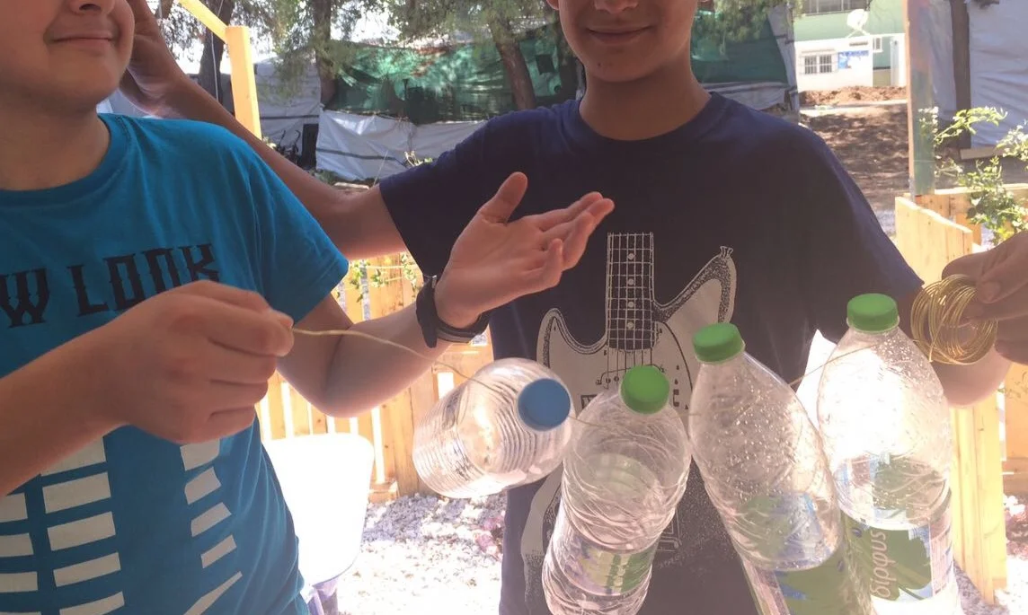 Members of the YES show off their water bottle sculpture