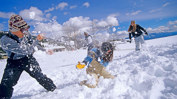 Kids friends playing snowball fight together