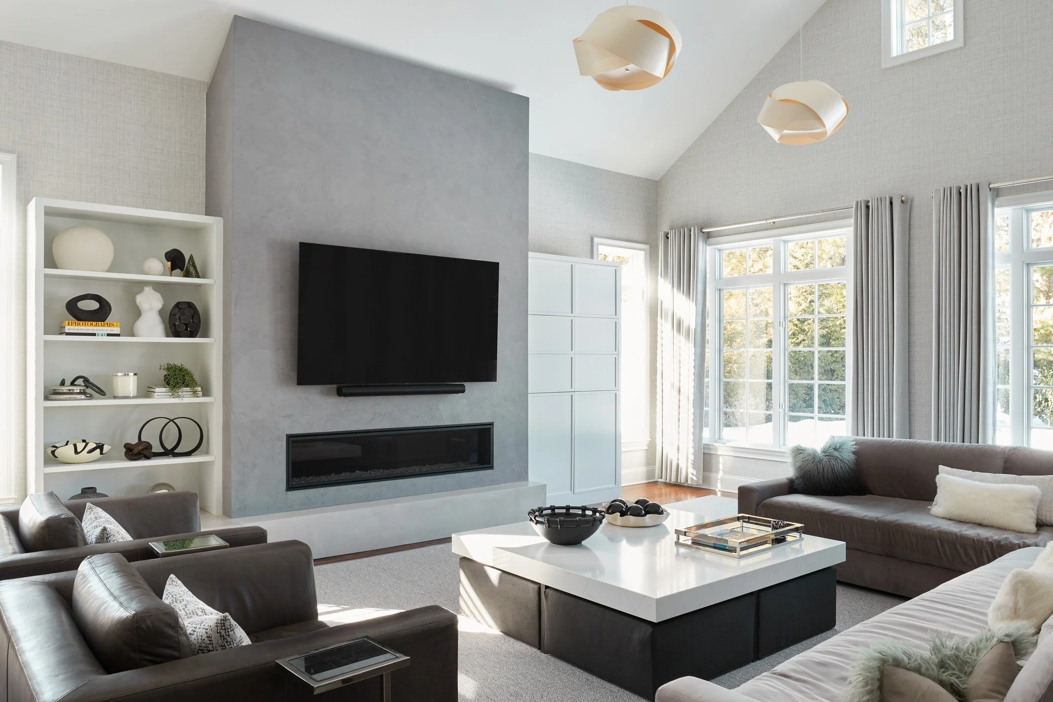 This before was quite a statement (swipe). My client wanted to ensure their love of watching sports on two TVs was integrated into their new family room design. They also wanted to reuse all their furniture and curtains. Even with these requests, you