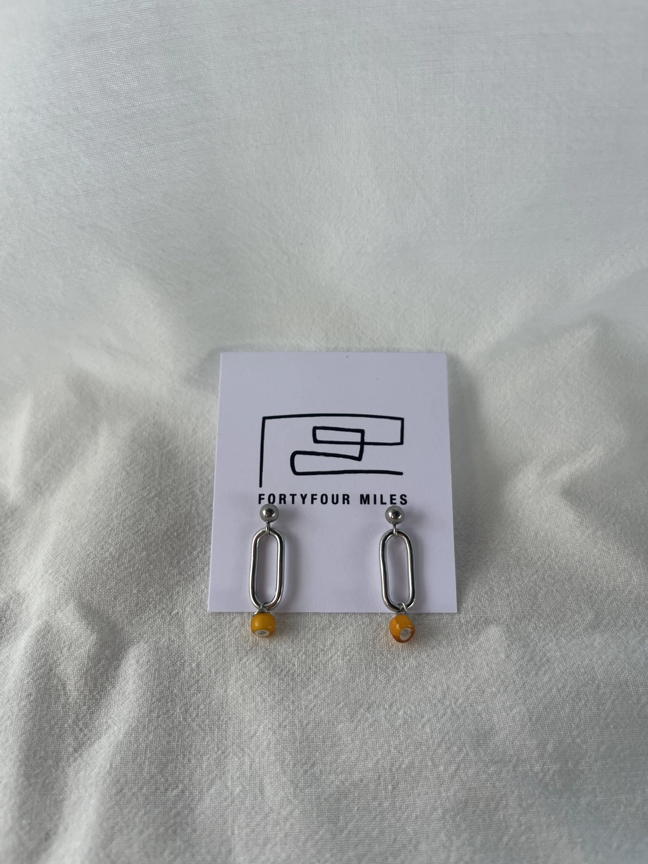 Link drop earring orange glass bead.JPG