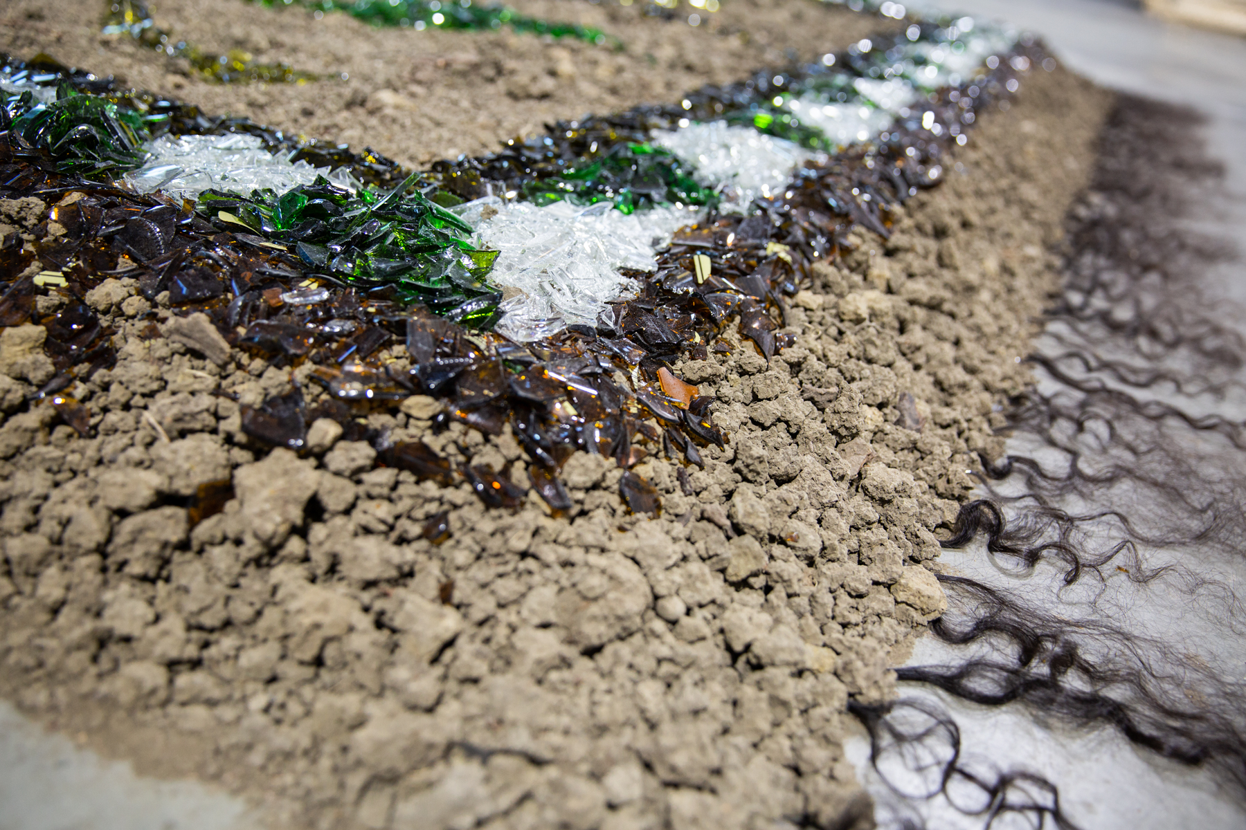  2018, Dirt, broken wine and beer bottles, Iranian female hair, , artist hair, 20 ft x 12 ft x 1 ft 