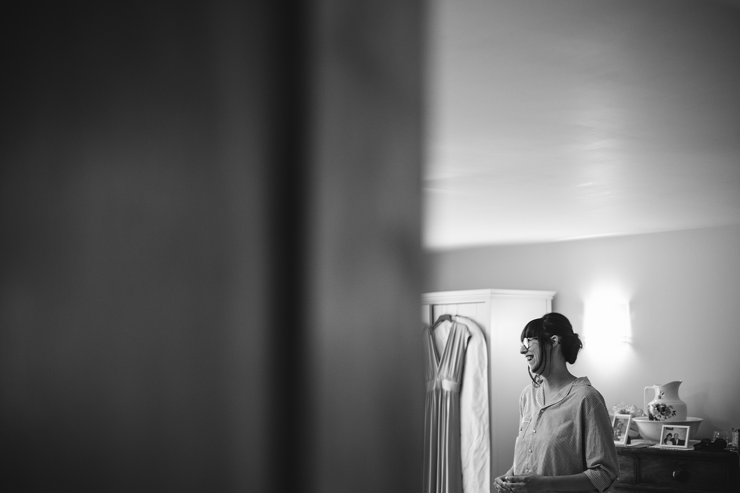 Bride laughing whilst getting ready
