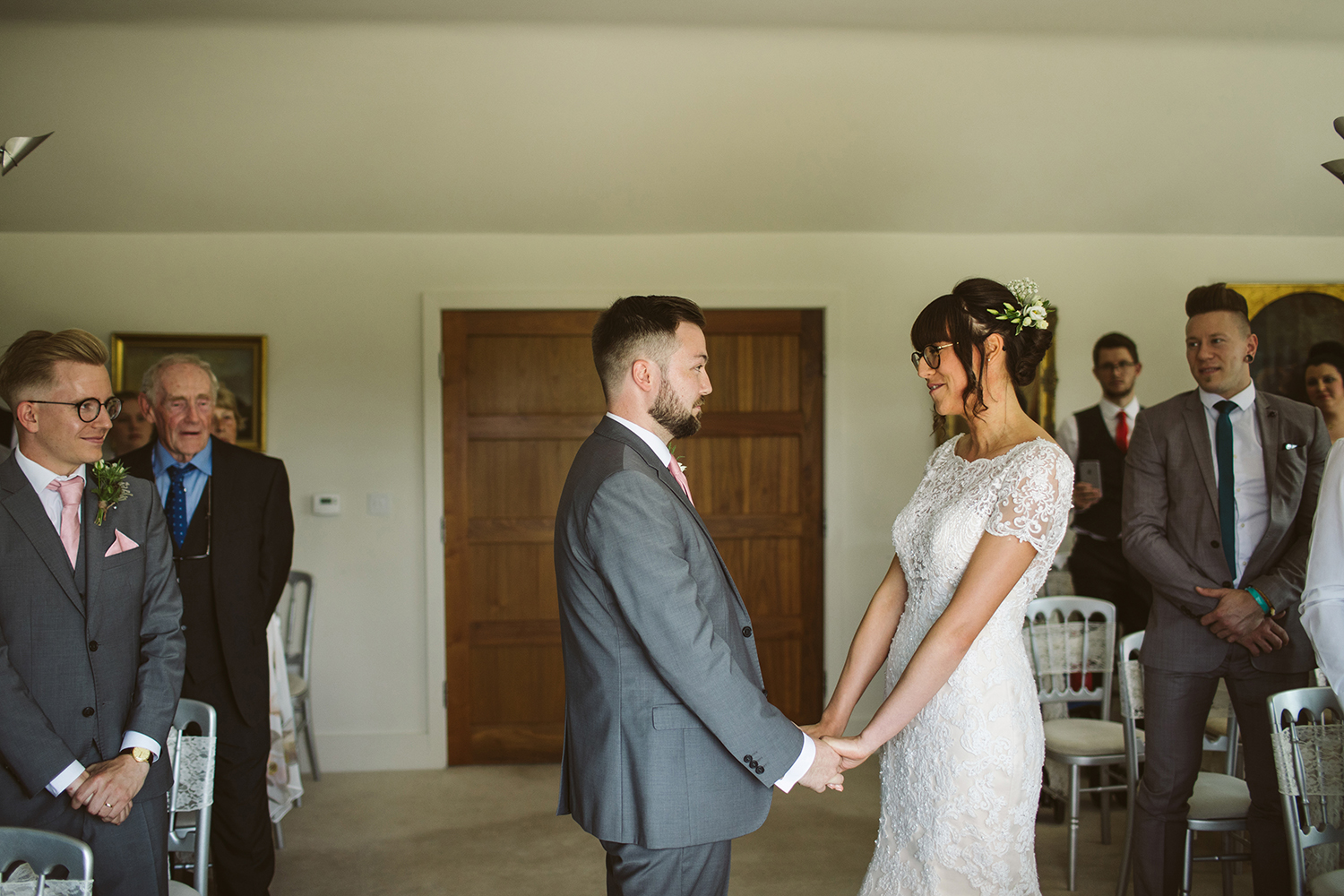 Groom and Bride holding hands at the alter