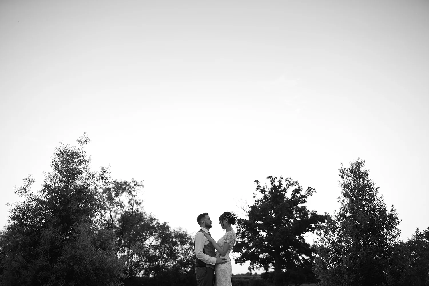 Bride and Groom kissing on the lawn