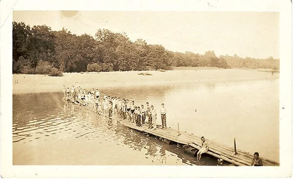  Boys stand on a dock at Camp Henry Pratt in the early 1900s. 