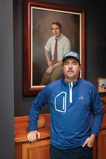 Wilkes Bryan stands in front of a portrait of his father, George Bryan, at Old Waverly.