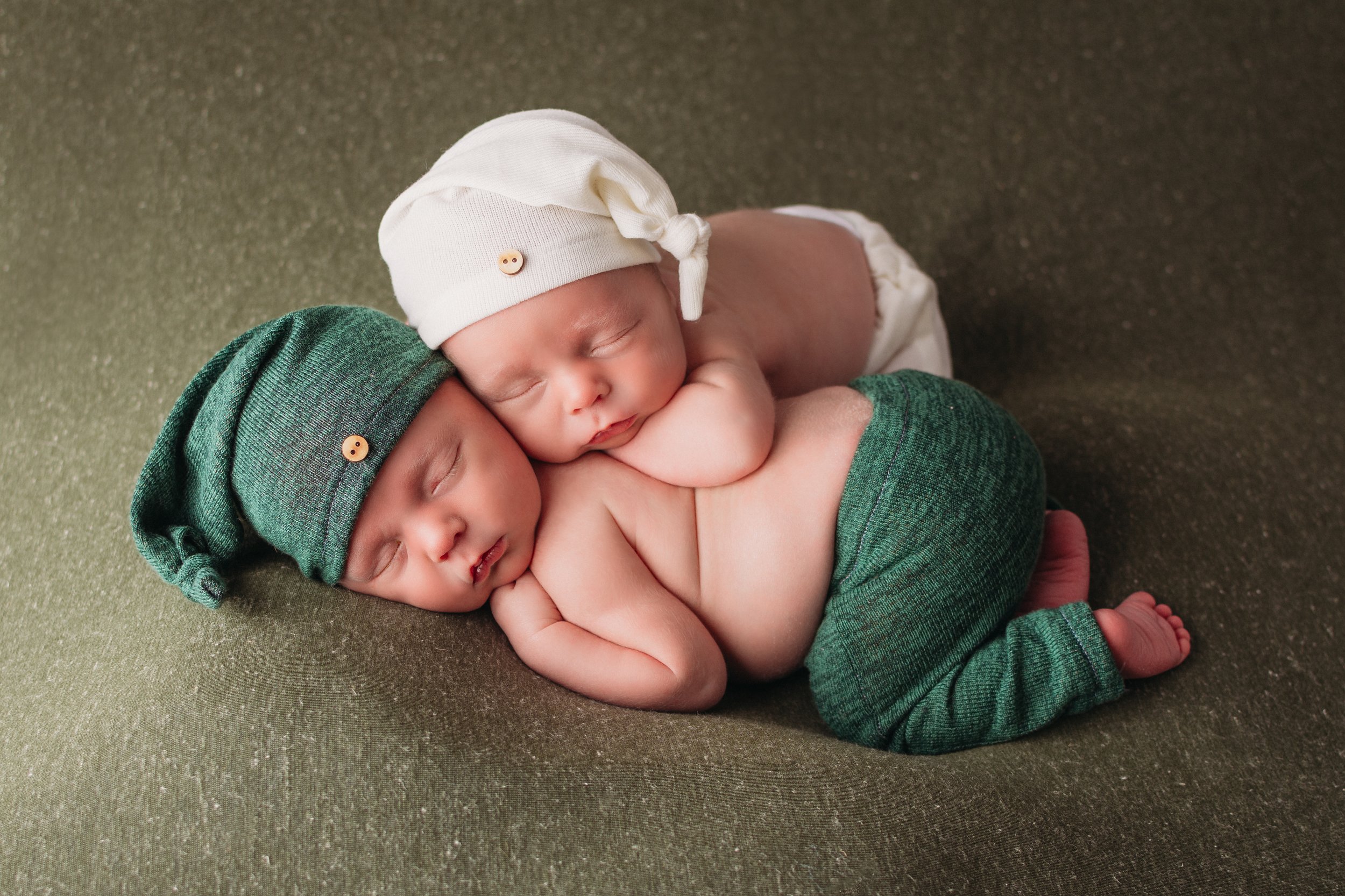 Newborn baby boy twins sleeping snuggled