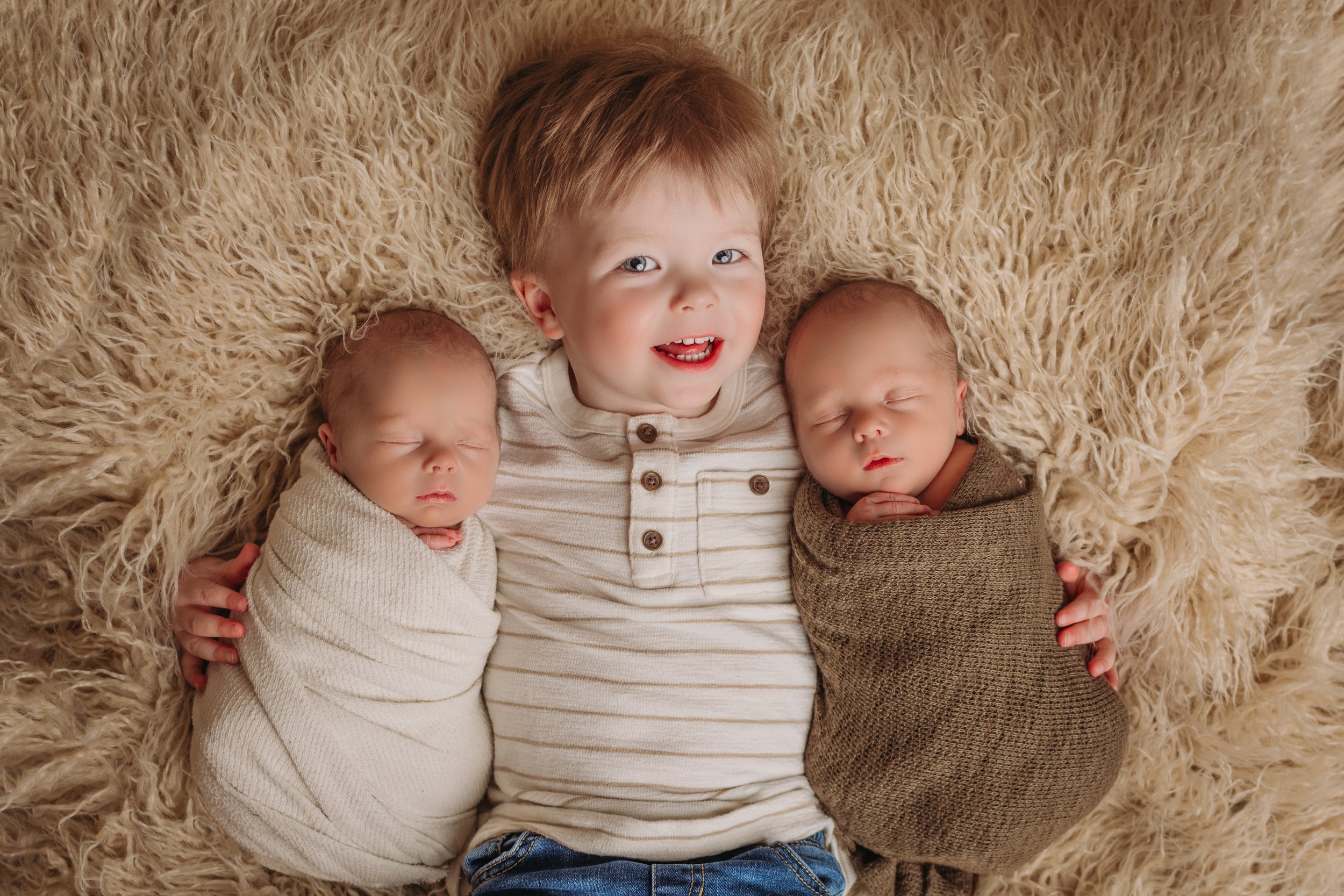 big brother with newborn twin brothers