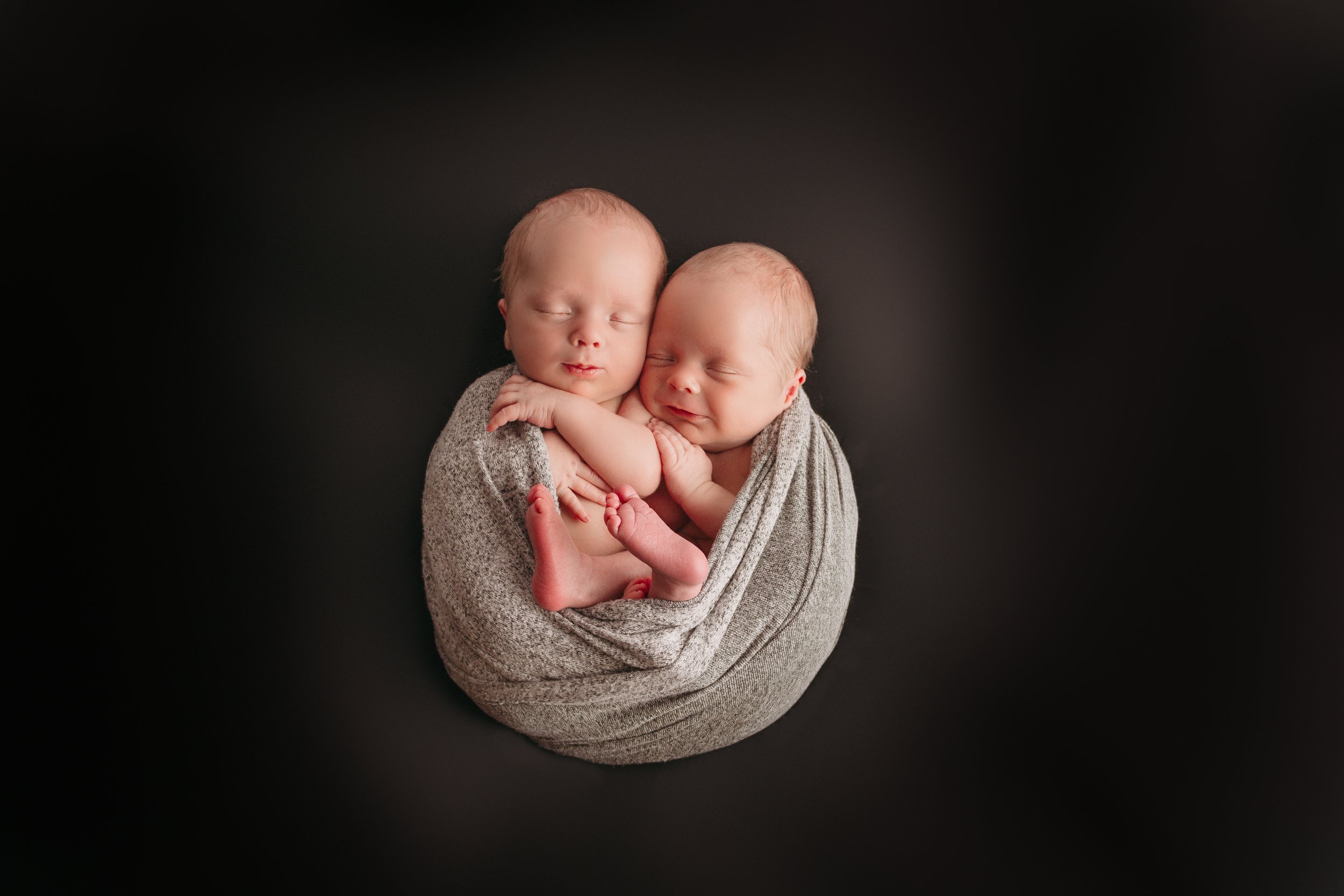 Newborn twins wrapped together
