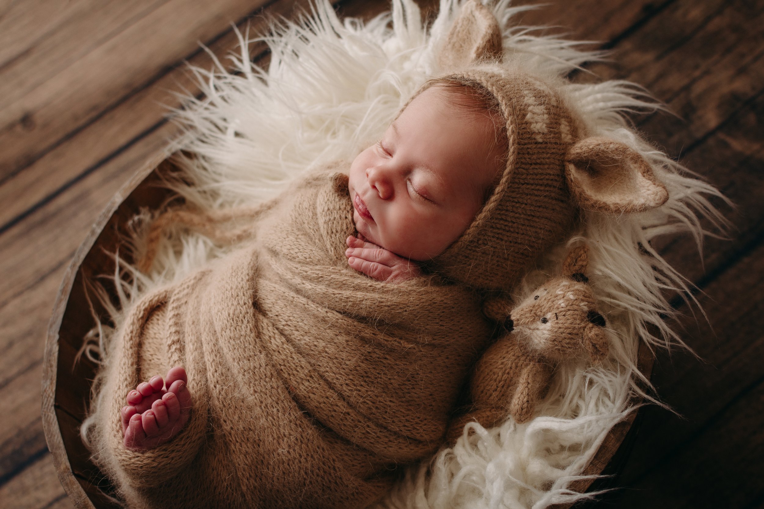 newborn baby in deer outfit rustic