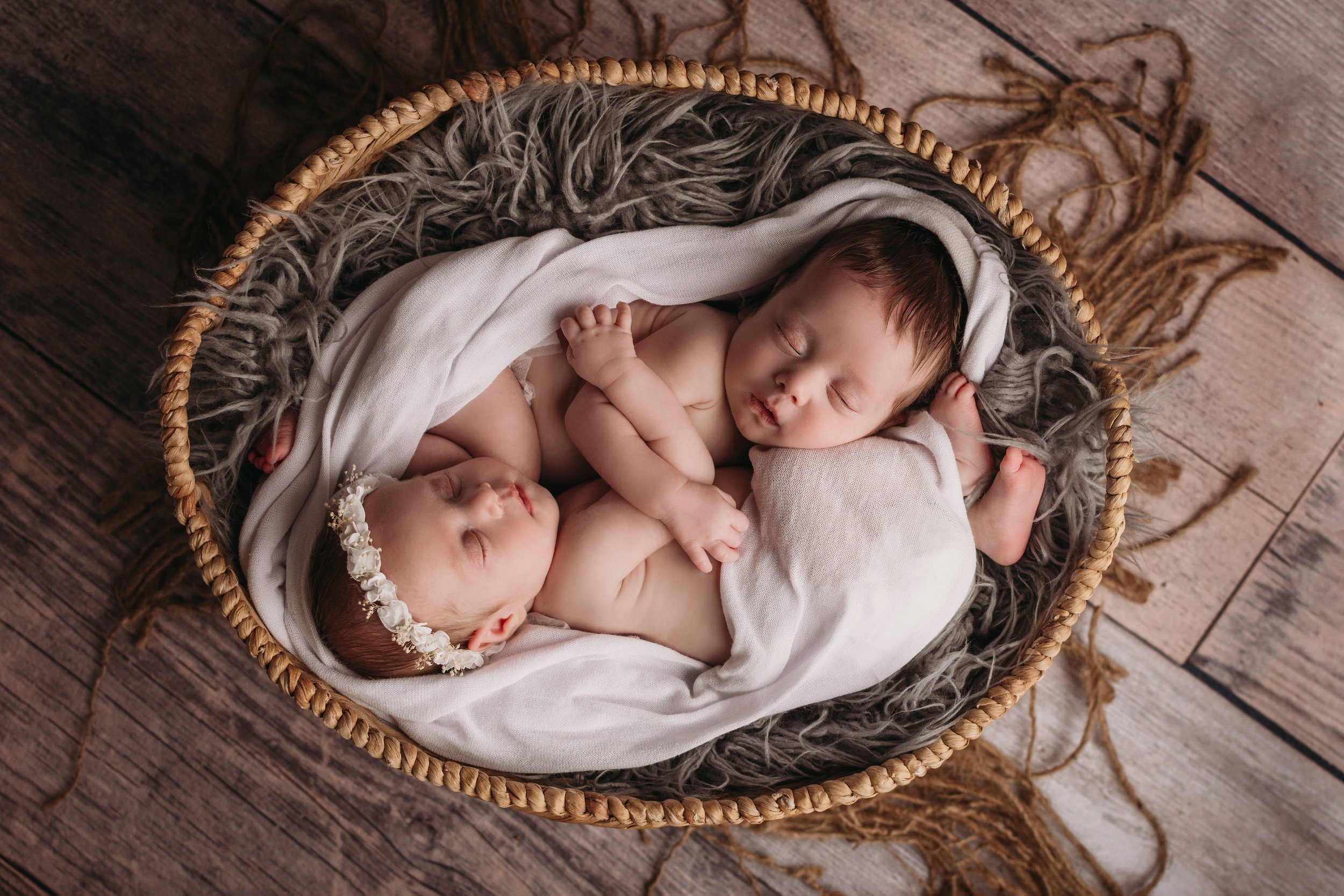 newborn twins wrapped in basket together