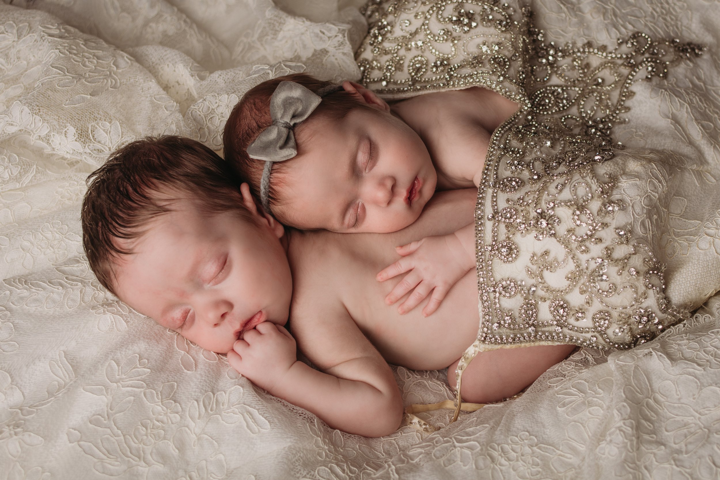 Newborn boy girl twins with moms wedding dress