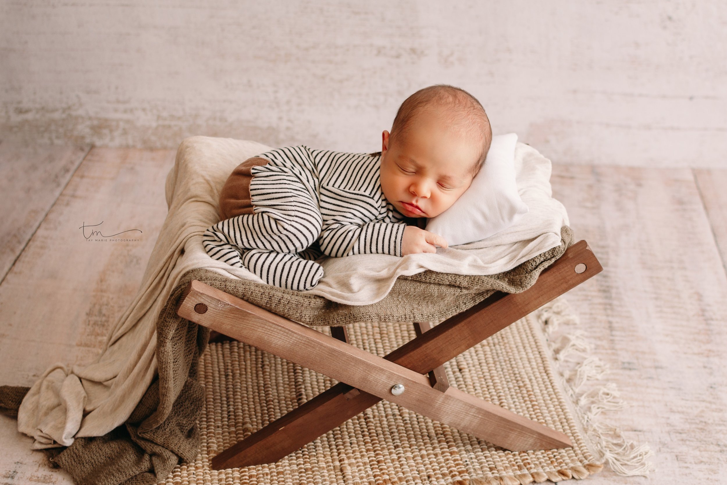 Newborn baby boy laying on bed