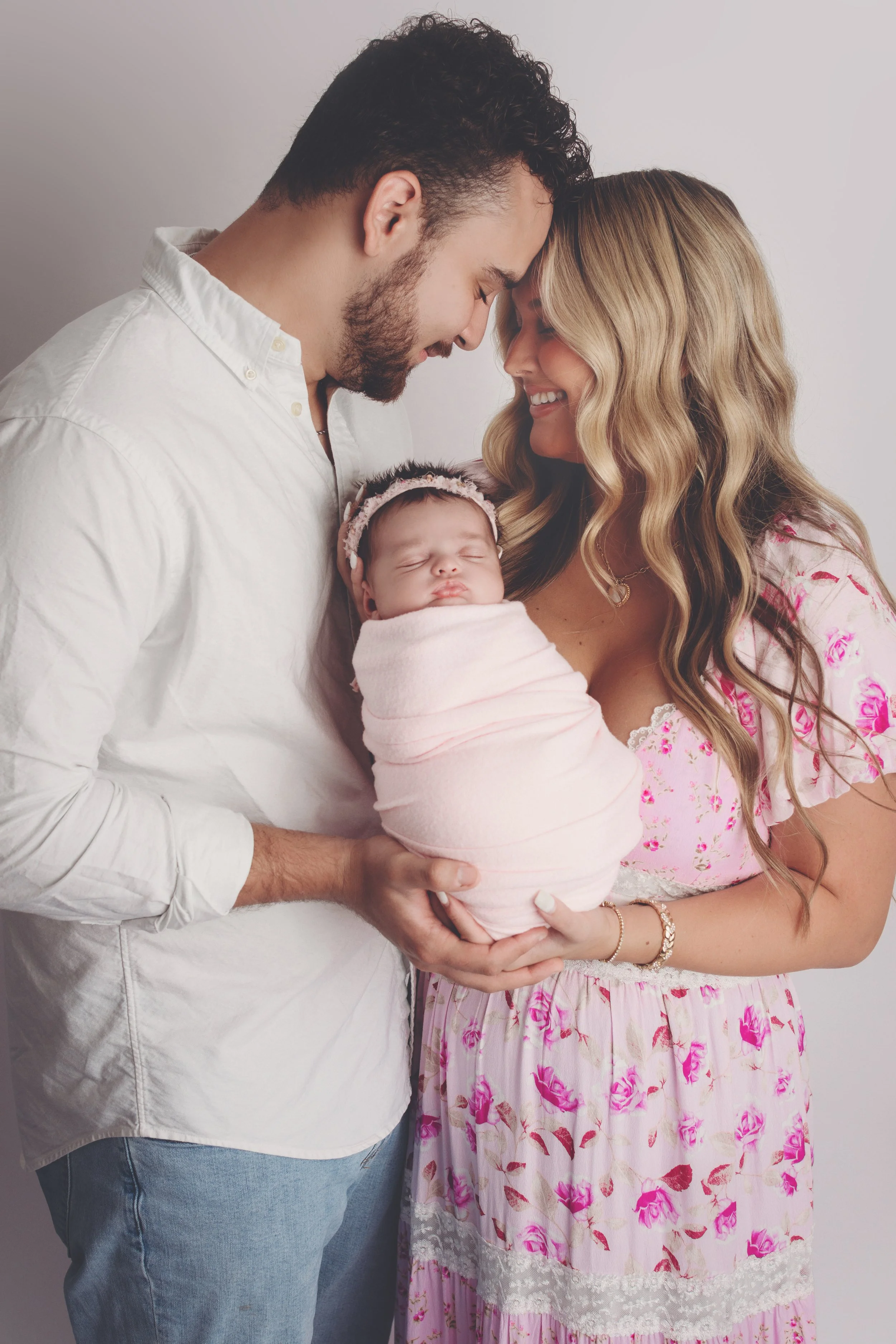 mom and dad with baby girl 