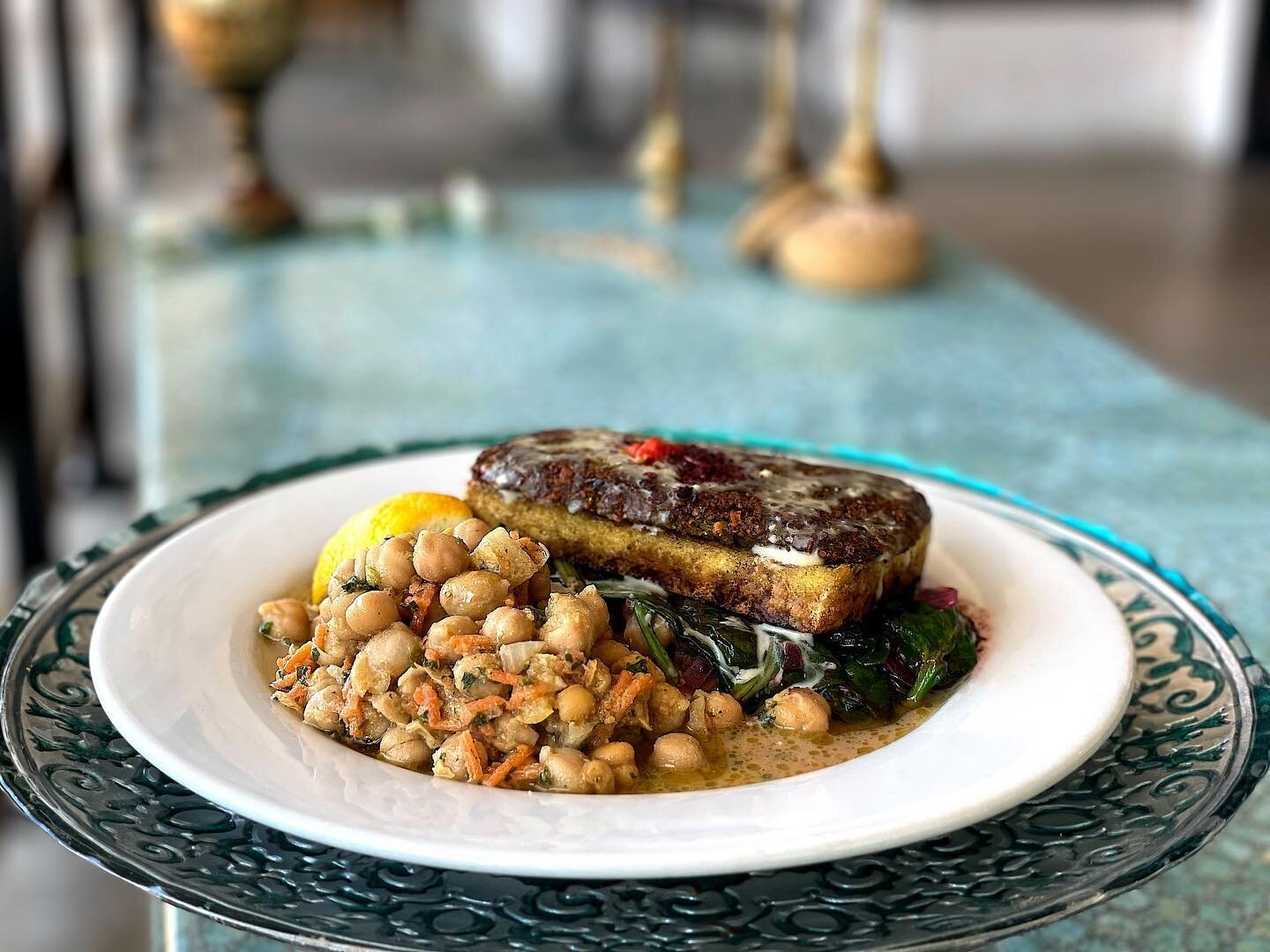 Falafel Encrusted Tofu is Twin Oaks organic Virginia tofu encrusted with falafel, baked and served over Sabanekh (saut&eacute;ed baby spinach, diced red onions, sumac and lemon-olive oil) with a side of chick peas salad. Come enjoy it today!
&bull; 
