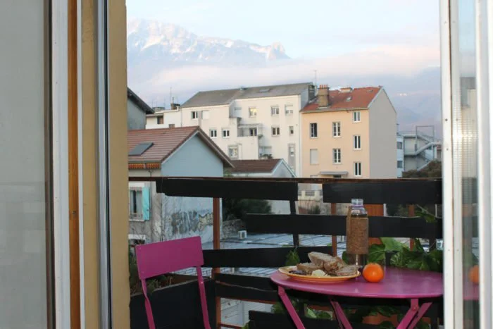 Breakfast of bread, fig jam, vegan cheese and tea with the Chartreuse mountain in the background…PC: Juhea Kim