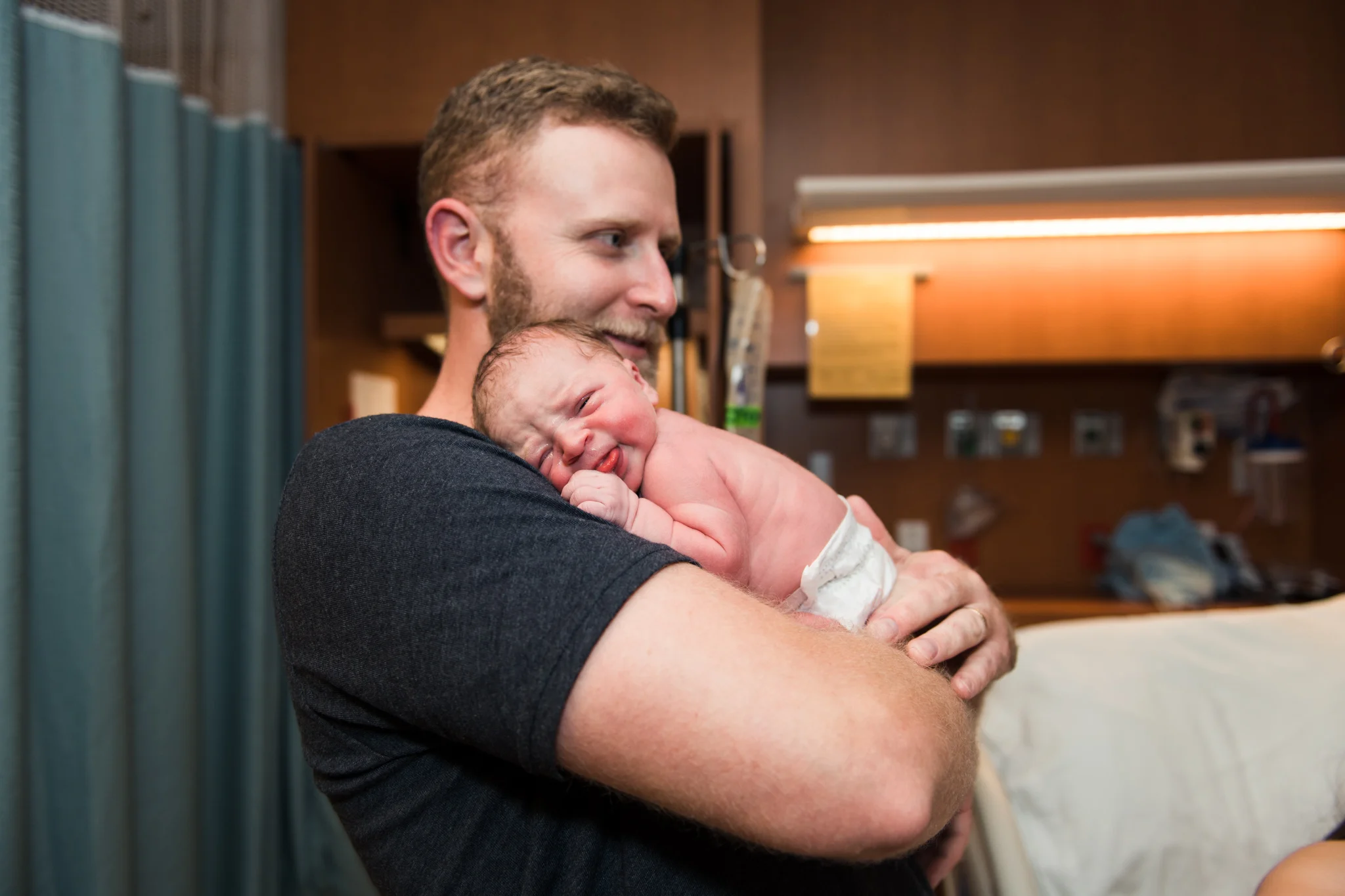 dad-smiling-while-holding-baby