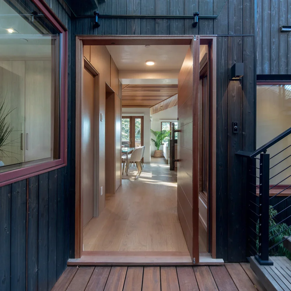 Exterior_of_the_Brisa_Home_in_Carmel_Showing_the_Walkway_into_Home_With_Dark_Burnt_Wood_Outdoors.webp