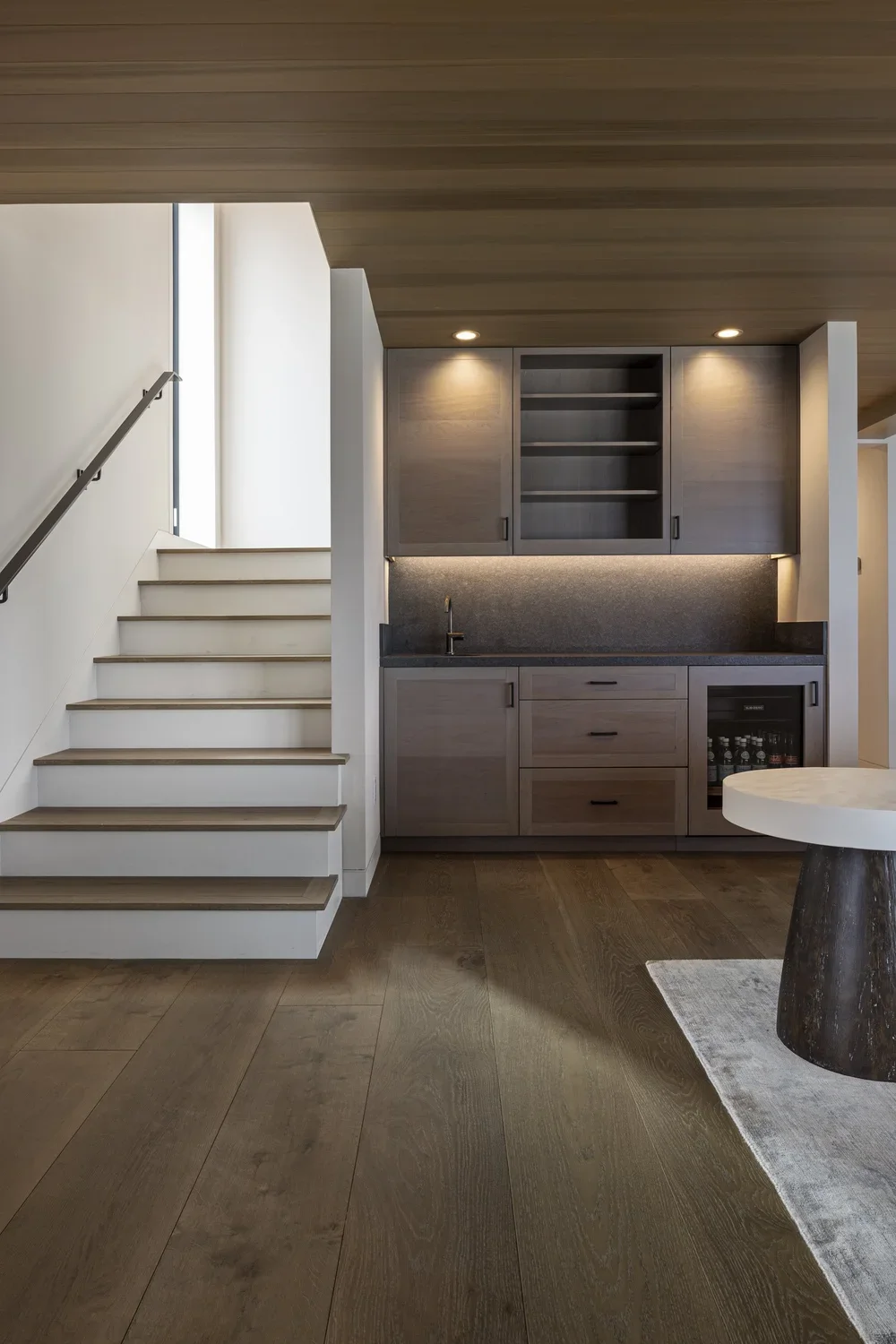 Interior_of_Monterey_Bay_House_Showing_Dark_Wood_Modern_Finishes_and_Ascending_Staircase.webp