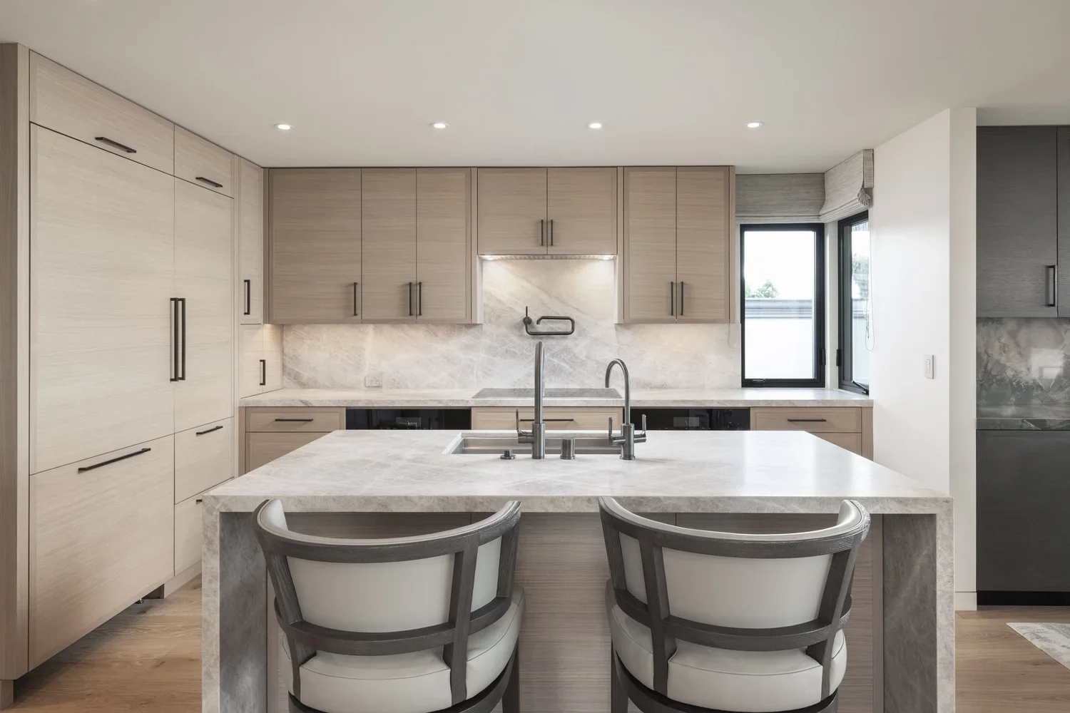 Interior_of_Sea_Mist_Home_in_Carmel_Showing_Dining_Area_and_Kitchen_With_Sink_in_Island.webp