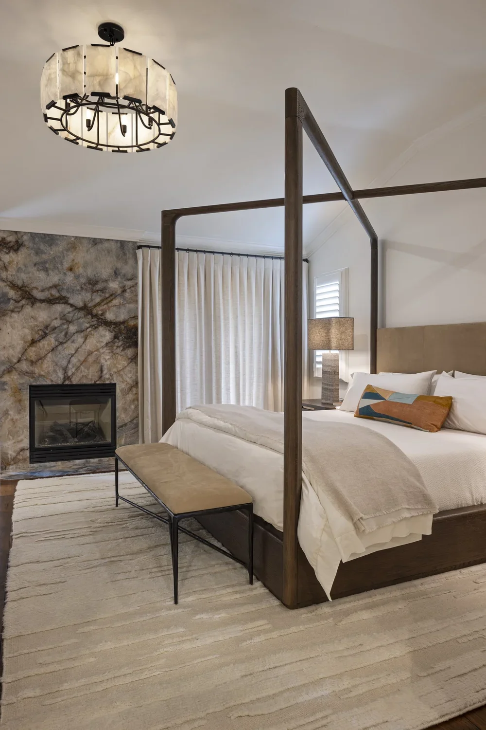 Interior_of_Quail_Modern_House_Showing_Bedroom_With_Overhead_Corner_Bedframe_And_Stone_Light_Fixture.webp