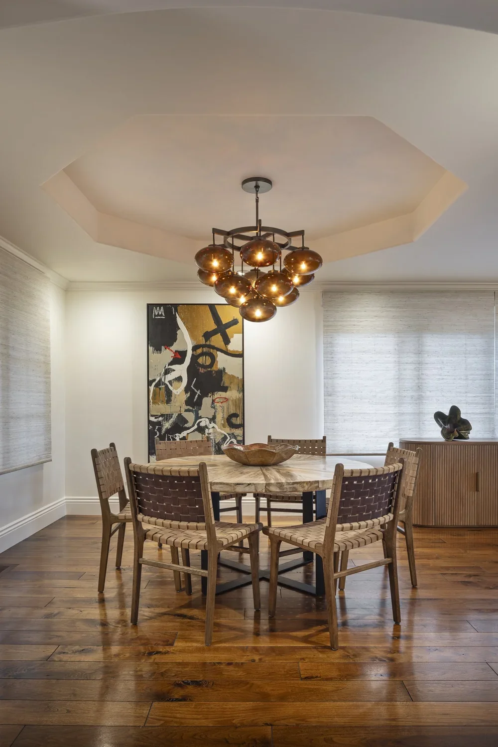 Interior_of_Quail_Modern_House_Showing_Dining_Area_With_Interesting_Amber_Chandelier.webp