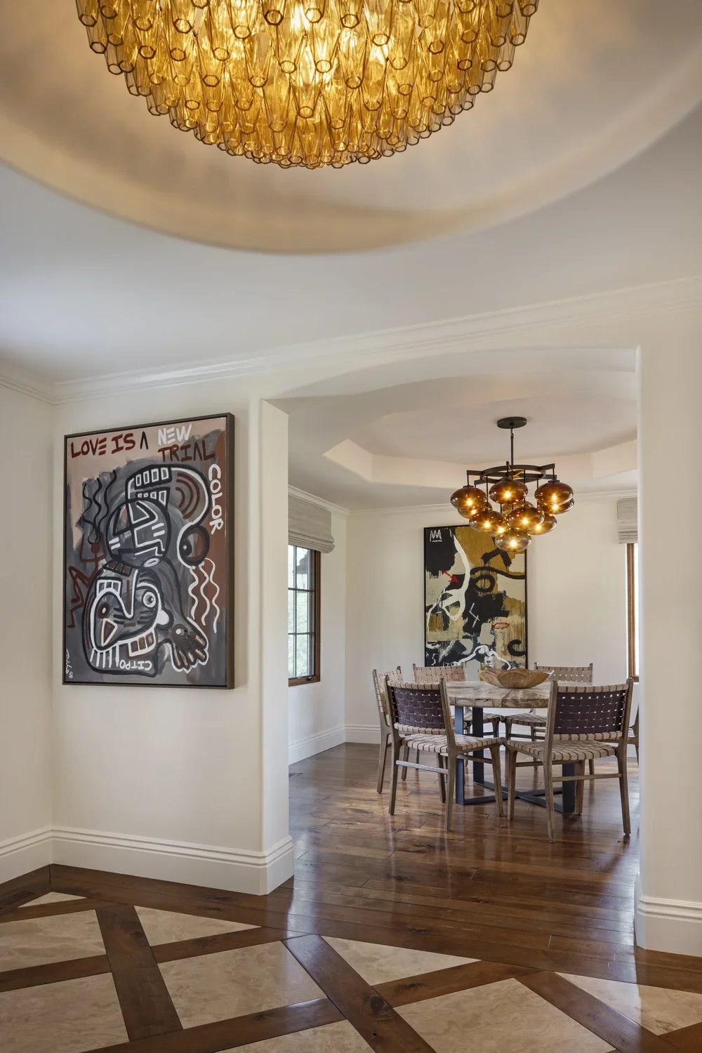 Interior_of_Quail_Modern_House_Showing_Hallway_View_of_Dining_Area_With_Abstract_Painting_on_The_Wall.webp