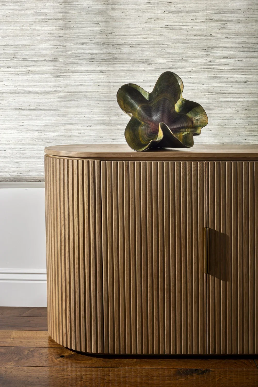 Interior_of_Quail_Modern_House_Showing_Light_Wood_Floor_Cabinet_Table_With_Abstract_Metal_Sculpture.webp