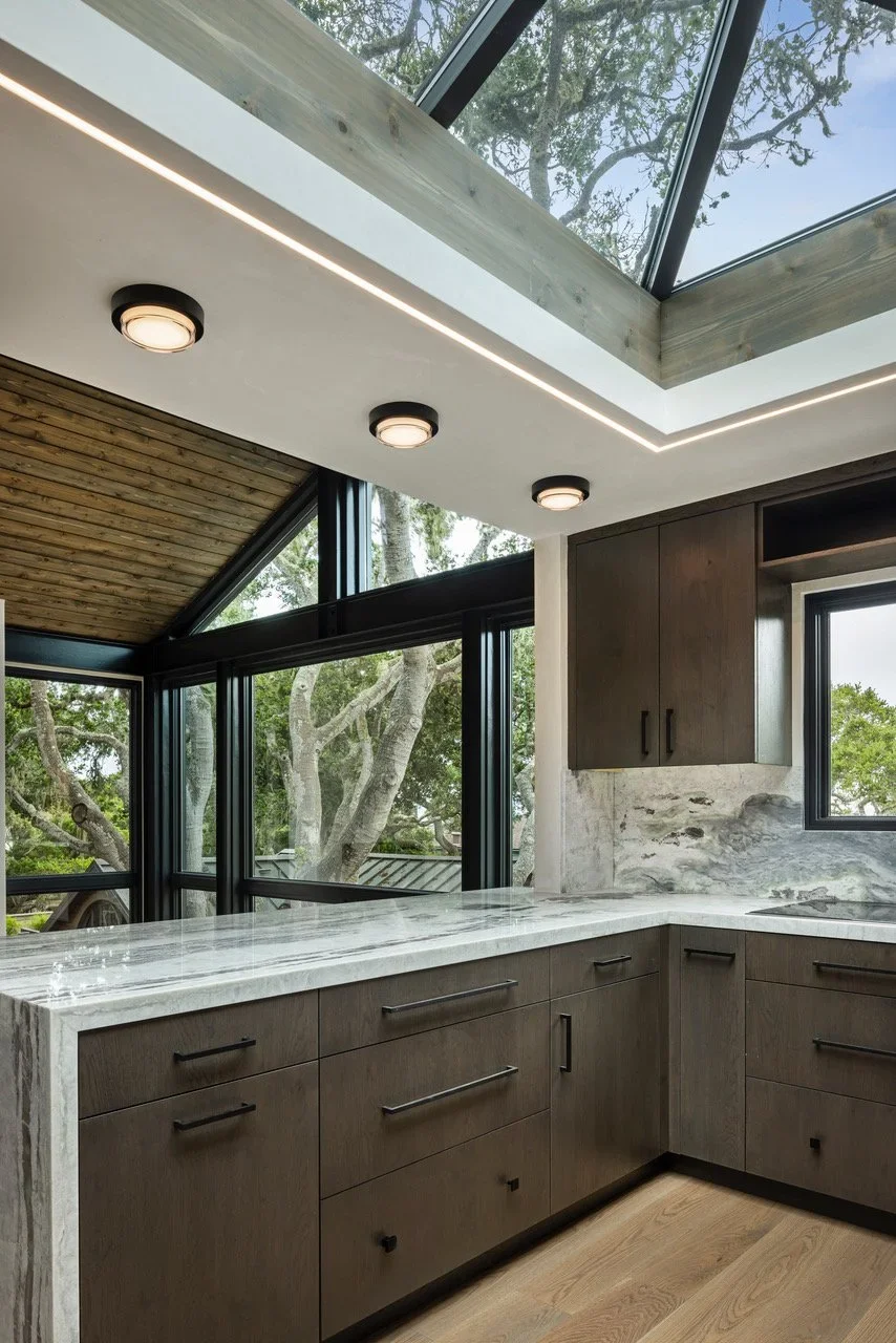 Interior_of_Treehouse_Showing_View_From_Kitchen_Out_To_Large_Pane_Windows_to_Outside.webp