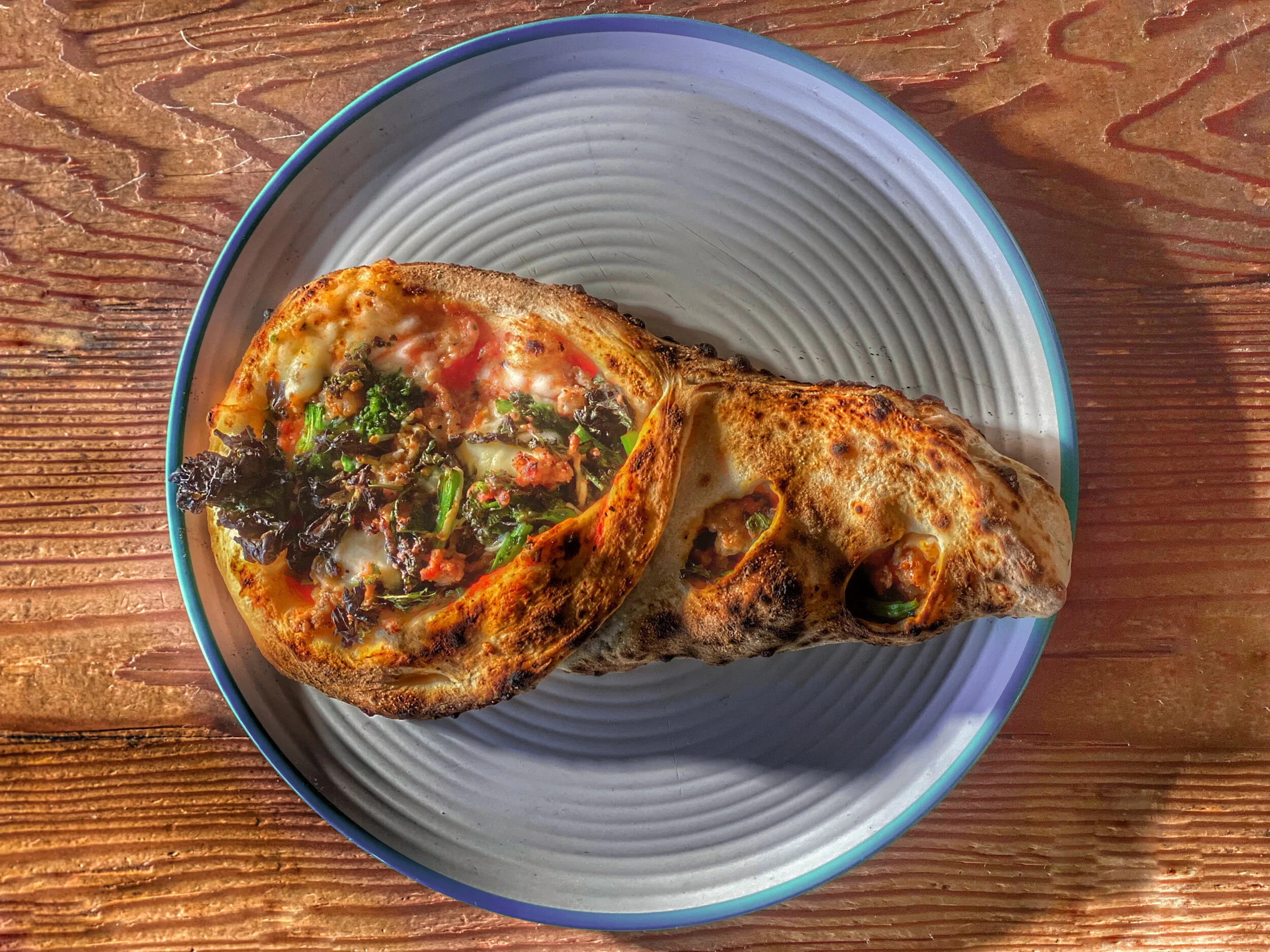 Golden-brown calzone filled with artisan ingredients, freshly baked by Chef Dominick Maietta.