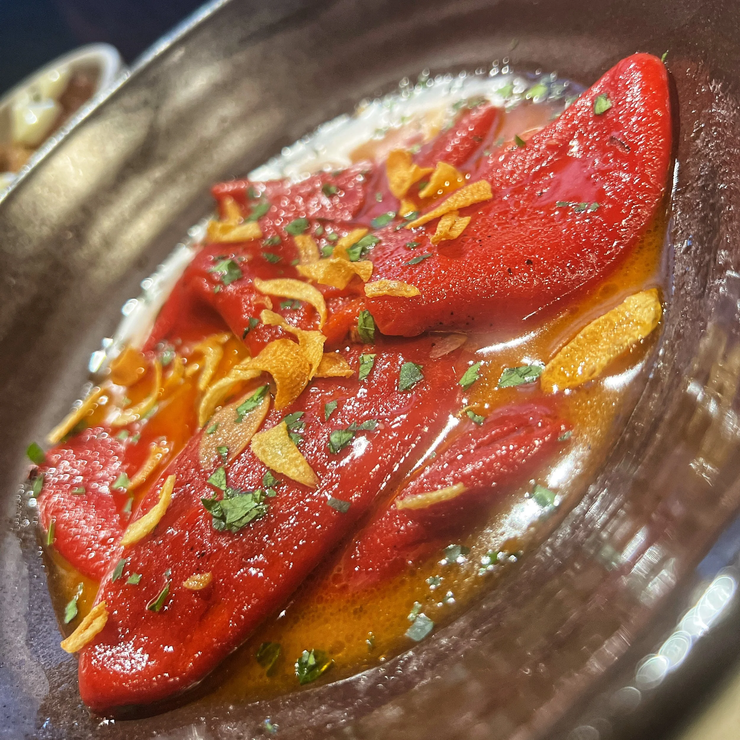 Confit piquillo peppers with Gilroy garlic, crafted by Chef Dominick Maietta using seasonal California ingredients.