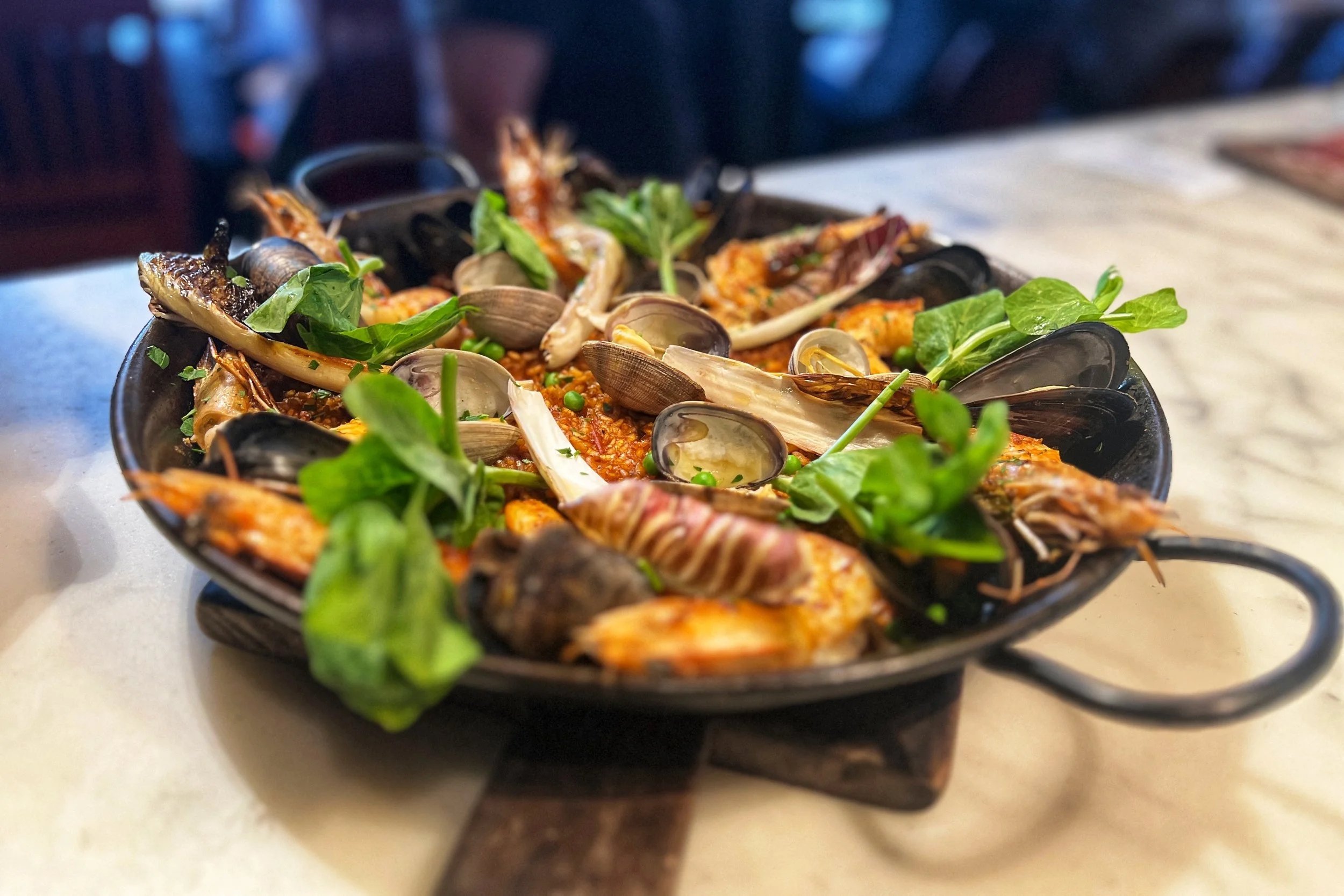 Traditional Spanish paella with saffron rice and seafood, prepared by Chef Dominick Maietta.