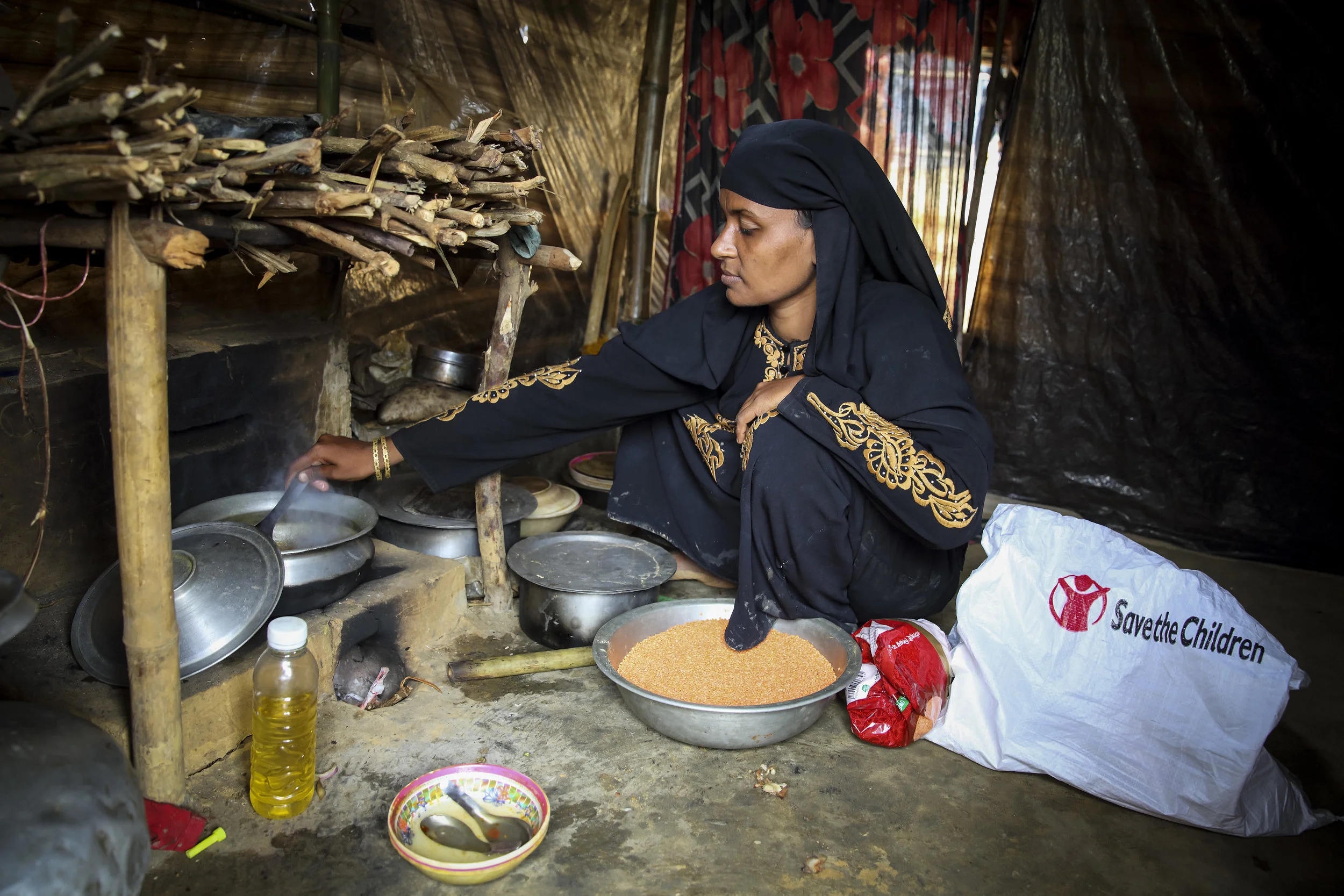 Photo caption: Morium* preparing lunch for her family with the aid she received from Save the Children. Photo credit: Save the Children. Date: January 2018.