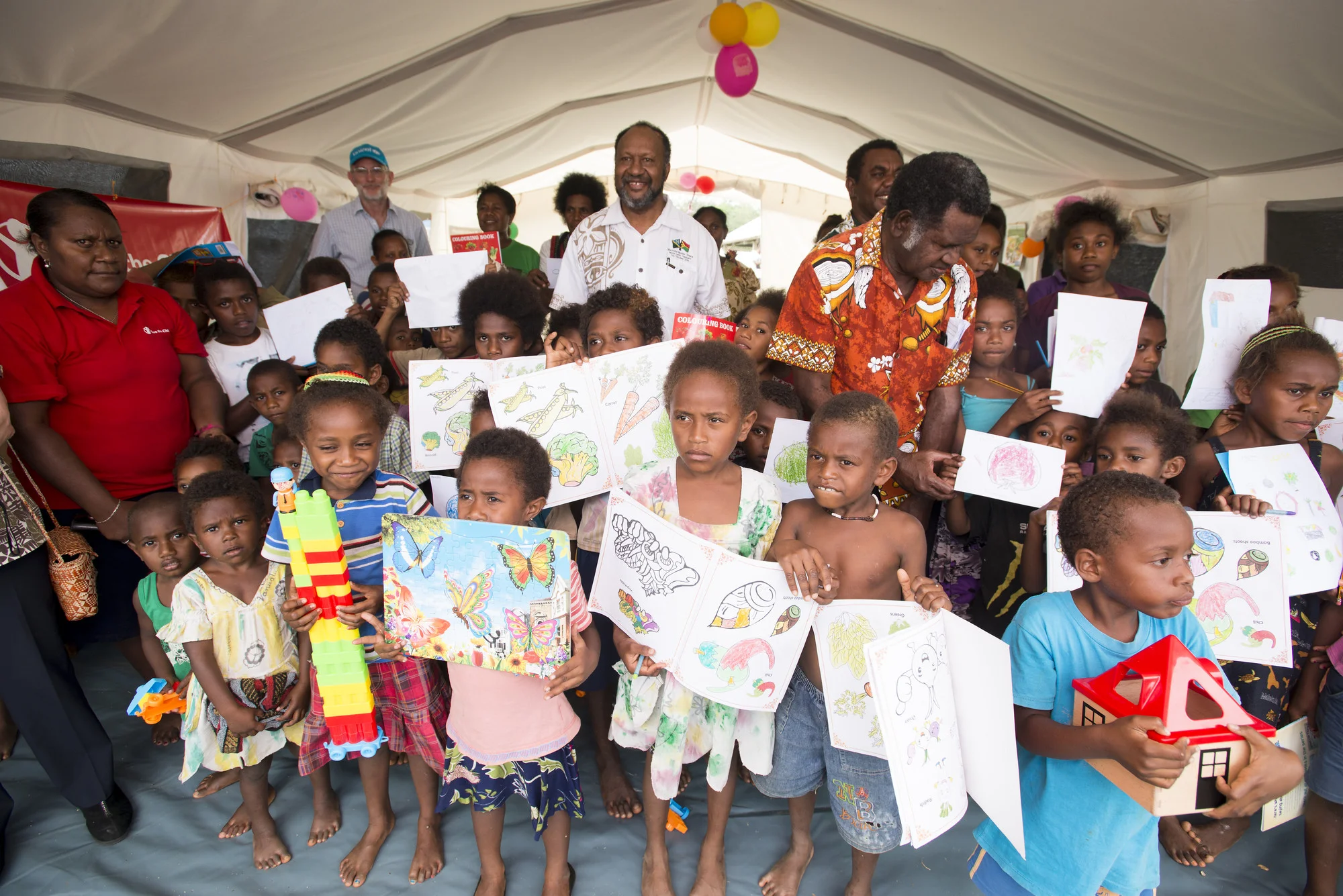 Photo caption: Prime Minister Charlot Salwai visits Save the Children’s Child Friendly Space in Chapuis Stadium. He spent time talking to children and staff, and stressed the importance of children maintaining their schooling. Photo credit: Save the Children.