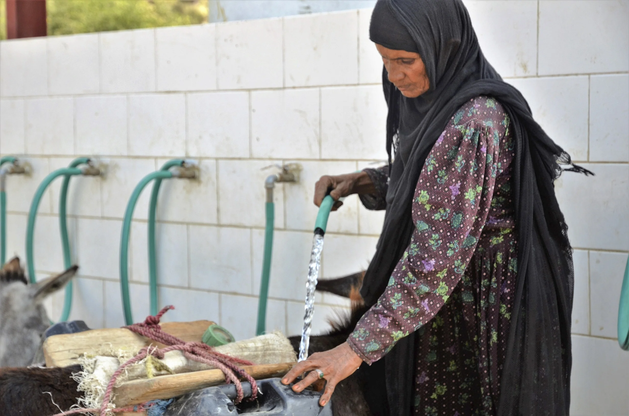 Photo caption: Hajja Khadija collects clean water from the water point constructed by Save the Children. Photo credit: Save the Children.