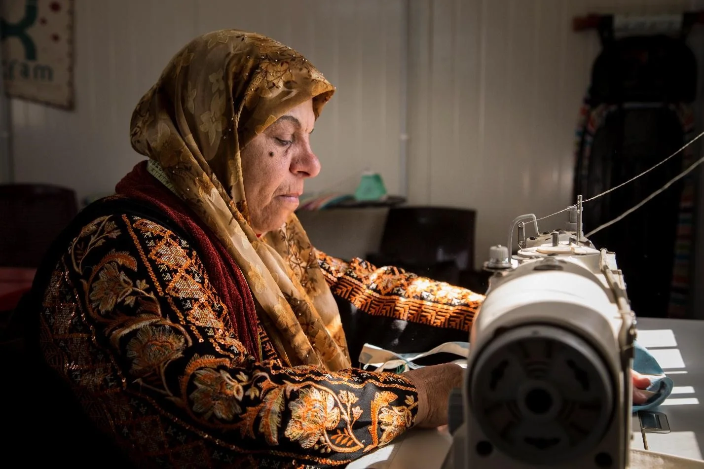 Above: Fatima sews bags from old refugee tents as part of an Oxfam project to support women in finding paid work. Photo credit: Nesma Alnsour/Oxfam